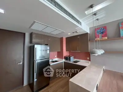 Modern kitchen with sleek cabinetry, stainless steel appliances, and stylish pendant lighting.
