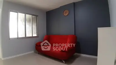 Modern living room with red sofa and stylish decor