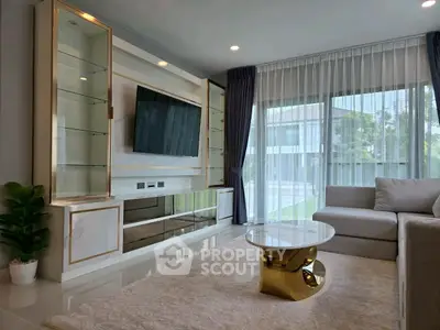Luxurious living room with modern decor, large windows, and elegant furniture in a stylish home.