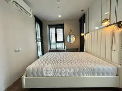 Modern bedroom with stylish decor and large windows in a luxury apartment.