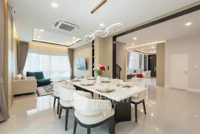 Luxurious open-plan living and dining area with modern decor and ample natural light.