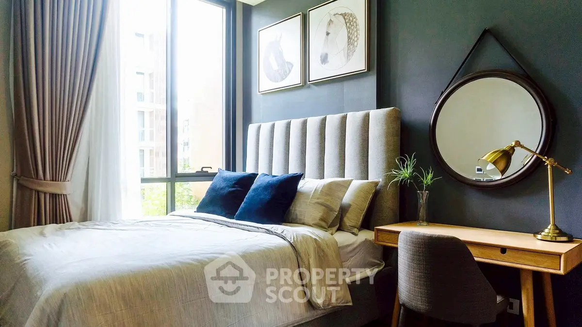 Stylish bedroom with modern decor and large window for natural light.