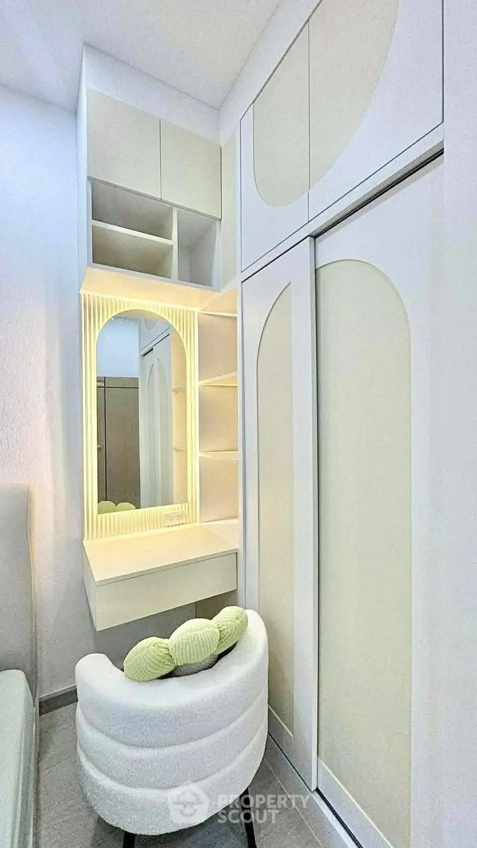 Modern bedroom with built-in wardrobe and stylish vanity mirror