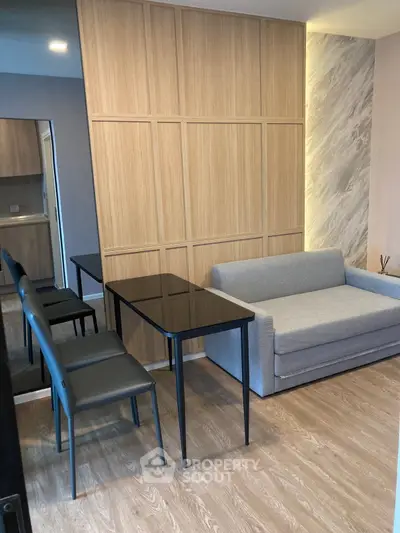 Modern living room with sleek furniture and wooden accents, perfect for cozy urban living.