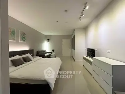 Spacious modern bedroom with sleek design and cozy ambiance