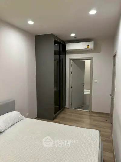 Modern bedroom with minimalist design and air conditioning unit