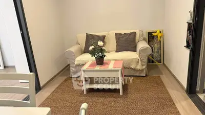 Cozy living room with a comfortable sofa and stylish decor in a modern apartment.