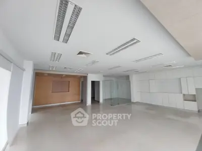 Spacious modern office interior with sleek design and ample natural light.