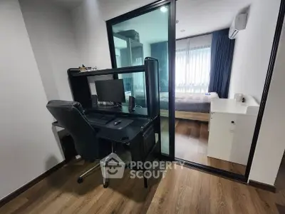 Modern study area with sleek desk and chair, adjacent to a cozy bedroom with natural light.