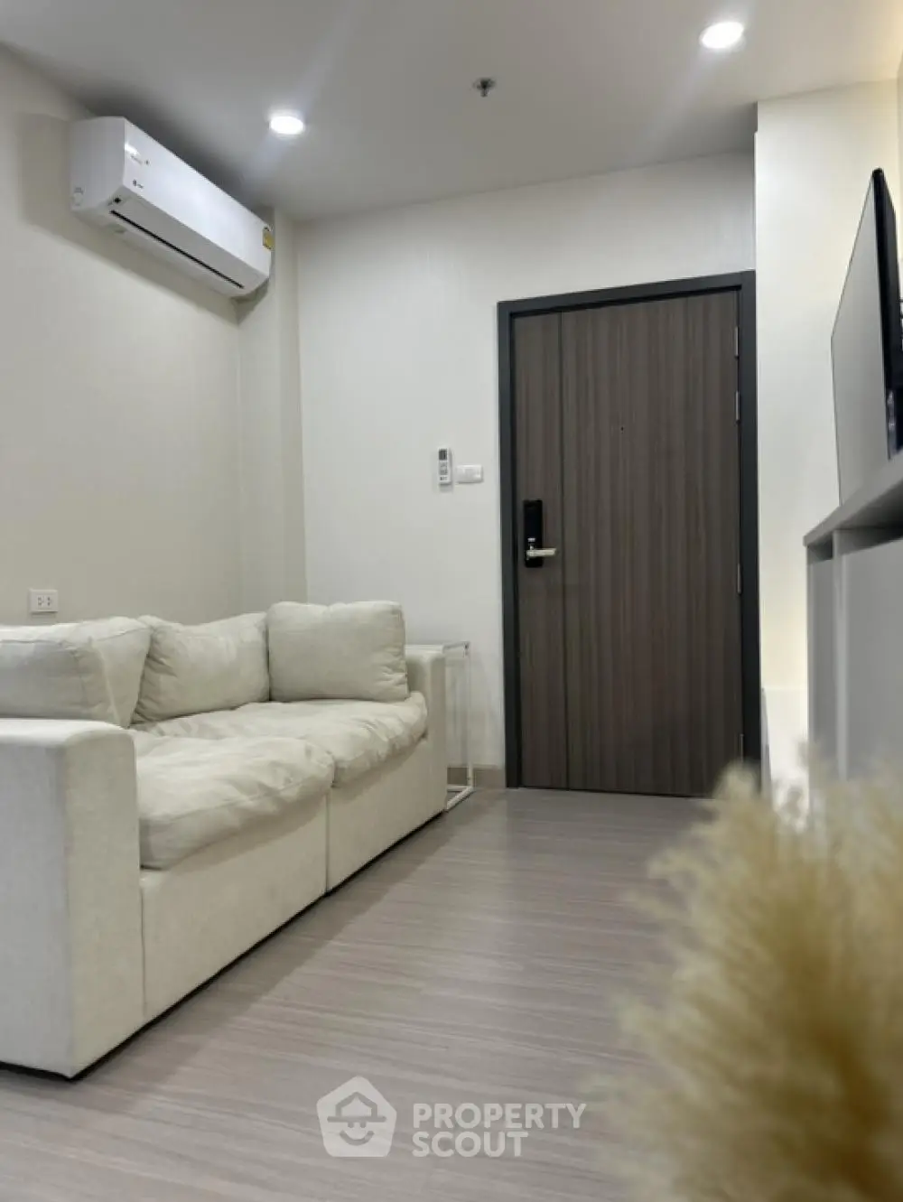 Modern living room with white sofa and air conditioning unit