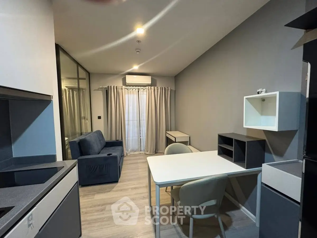 Modern studio apartment with sleek furnishings and ample natural light