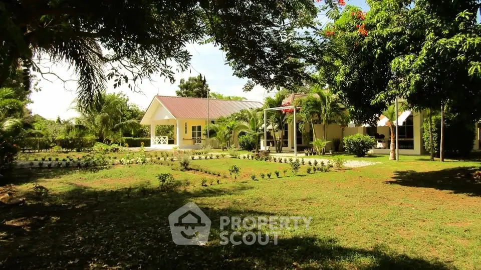 Charming countryside home with lush garden and spacious lawn, perfect for serene living.
