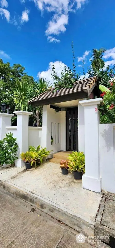 Charming garden entrance with lush greenery and modern gate design