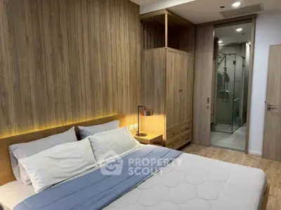 Modern bedroom with wooden accents and ensuite bathroom in luxury apartment