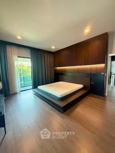Luxurious modern bedroom with platform bed and large window view.