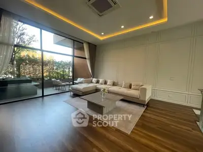 Luxurious living room with modern design and spacious balcony view.