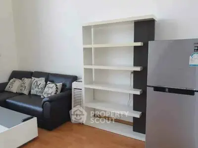 Modern living room with sleek furniture and stainless steel fridge