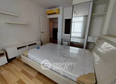 Spacious bedroom with modern furnishings and ample natural light.