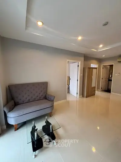 Spacious living room with modern decor and elegant lighting