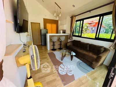 Charming living room with modern decor, cozy sofa, and natural light from large windows.