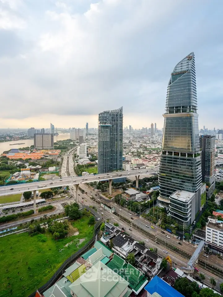 Stunning aerial view of modern skyscrapers and cityscape with lush greenery and highways.