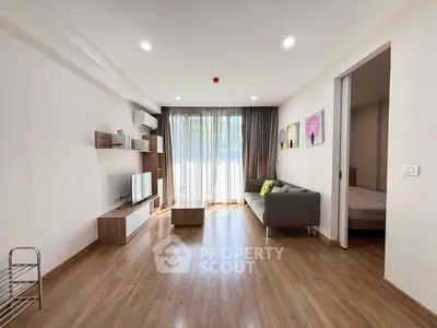 Spacious modern living room with wooden flooring and natural light