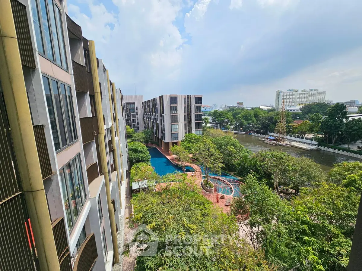Stunning aerial view of modern apartment complex with lush greenery and inviting pool area.