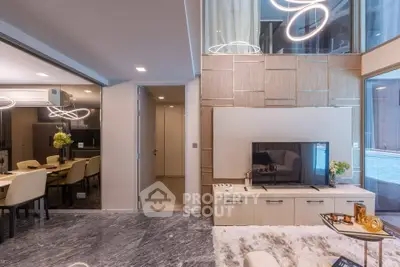 Luxurious modern living room with elegant decor and open dining area, featuring stylish lighting and marble flooring.