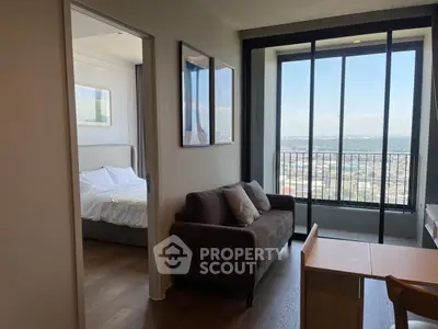 Modern apartment with cozy living room and stunning city view from balcony.