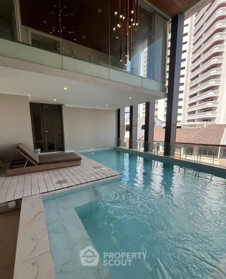 Luxurious indoor pool with modern design and city view, perfect for relaxation and leisure.