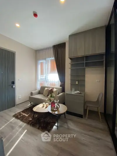 Modern living room with cozy seating and stylish decor in a contemporary apartment.