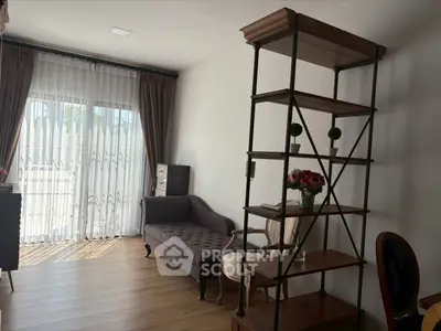 Elegant living room with natural light, featuring a stylish chaise lounge and modern shelving unit.