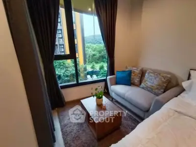Cozy bedroom with a scenic view, featuring a comfortable sofa and stylish decor.