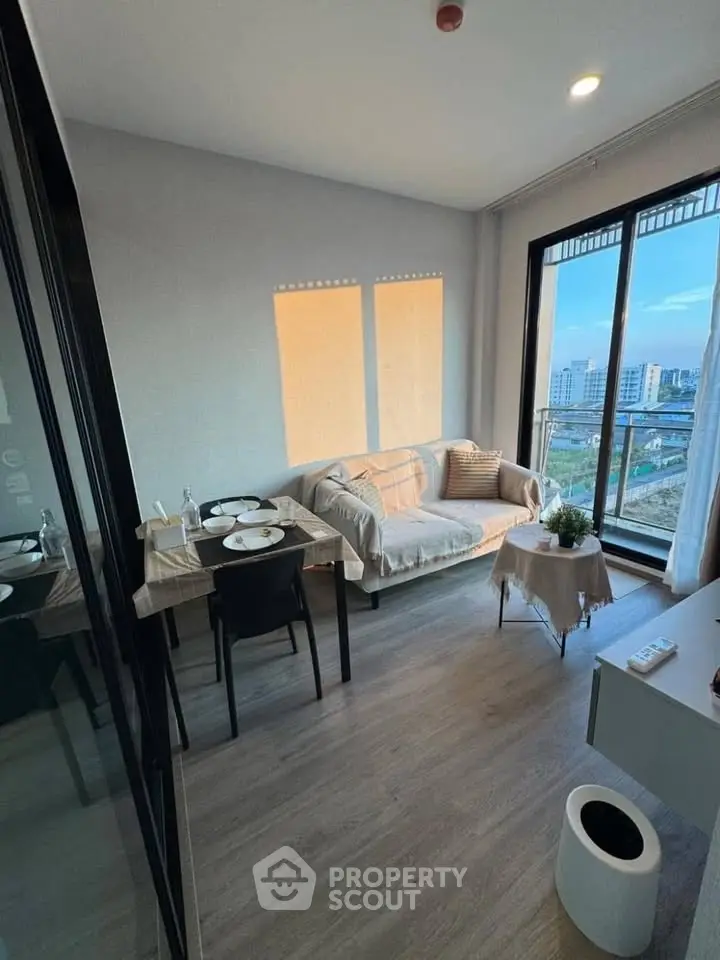 Modern living room with city view, featuring cozy sofa and dining area, perfect for urban living.