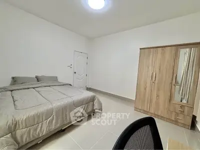 Spacious bedroom with modern furniture and neutral decor