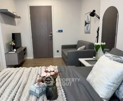 Cozy modern bedroom with stylish decor and comfortable seating area