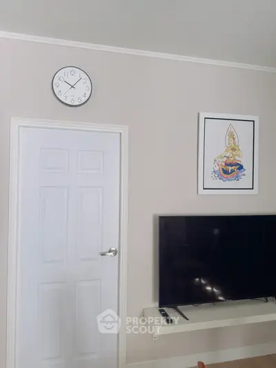 Modern living room with wall-mounted TV and stylish decor