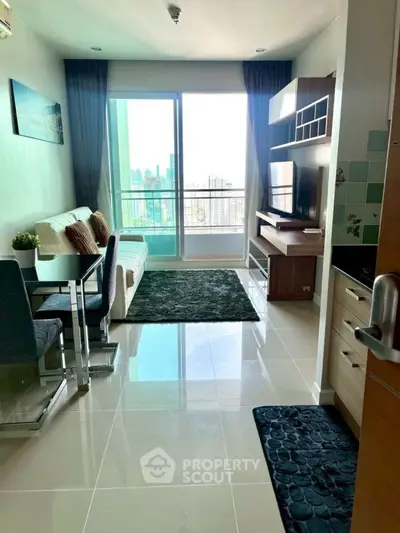 Modern living room with balcony view, sleek furniture, and natural light in a stylish apartment.
