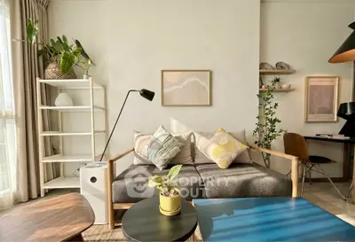 Chic living room with modern decor, cozy sofa, and natural light.