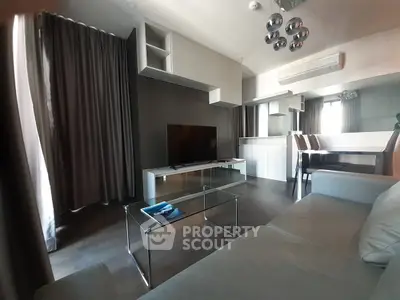 Modern living room with sleek furniture and large windows in a stylish apartment.