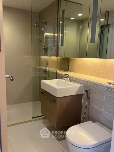 Modern bathroom with sleek fixtures and glass shower enclosure