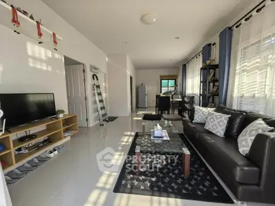 Spacious living room with modern decor and ample natural light