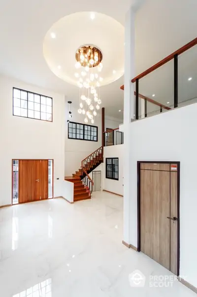 Luxurious modern living room with high ceiling and elegant chandelier