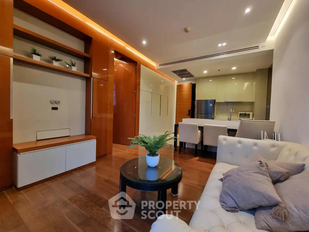 Luxurious modern living room with open kitchen, elegant decor, and cozy seating area.
