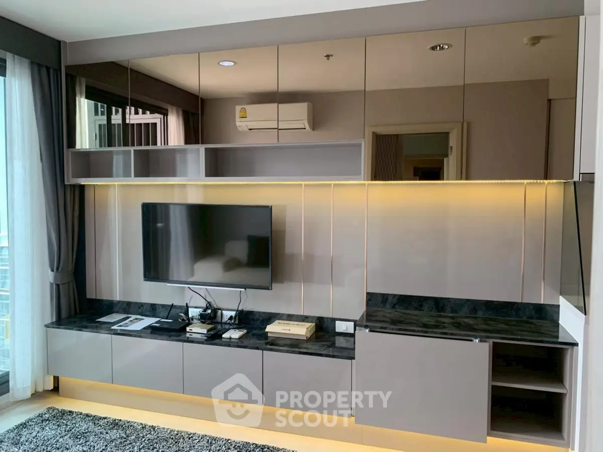 Modern living room with sleek TV unit and ambient lighting