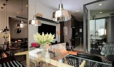 Modern open-plan living room with stylish dining area and sleek kitchen design.