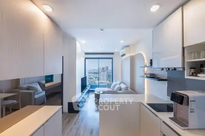 Modern open-layout living room with city view, sleek kitchen, and cozy seating area.