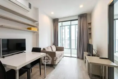 Modern living room with sleek furniture and large windows in a stylish apartment.