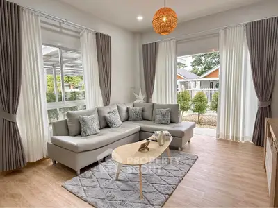 Modern living room with stylish decor and large windows offering natural light