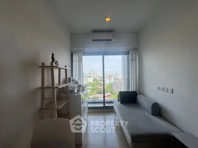 Modern living room with city view from large window, minimalist decor.